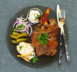 baked pork knuckle with pickles.