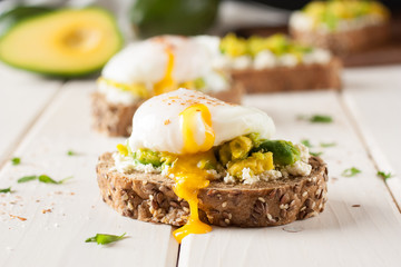 Breakfast sandwich with avocado and egg poached