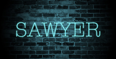 Fototapeta na wymiar first name Sawyer in blue neon on brick wall