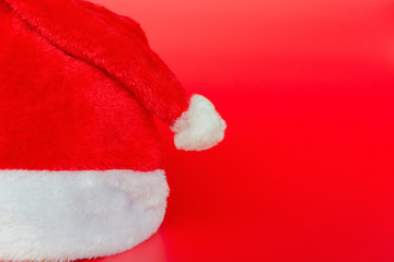 Obraz na płótnie Canvas Santa Claus hat on red background
