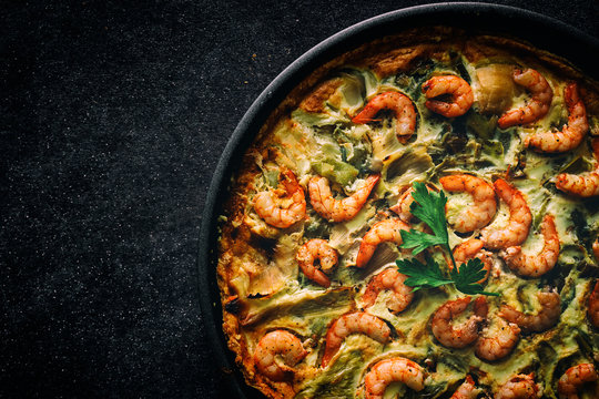 Homemade quiche of vegetables and prawns