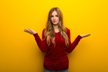 Young girl on vibrant yellow background unhappy and frustrated with something because not understand something