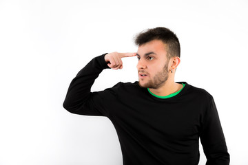 Nice and modern young with beard  touching his head with a finger  make the crazy gesture isolated on white background