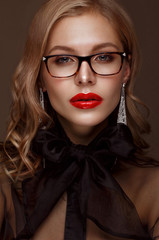 Beautiful girl in stylish clothes with glasses for vision and red sexy lips. Beauty face.