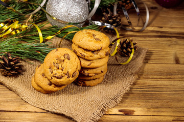 Chocolate chip cookies with Christmas decoration on wooden table
