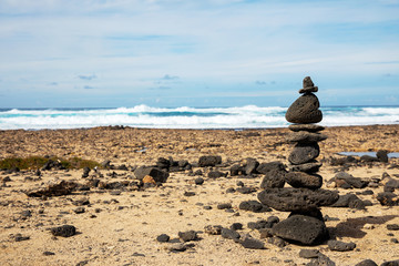 Stones pyramid on sand symbolizing zen, harmony, Stone balancing
