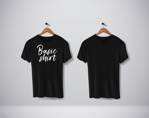 Black T-Shirts Mock-up clothes with lettering an V and round neck hanging on wall.