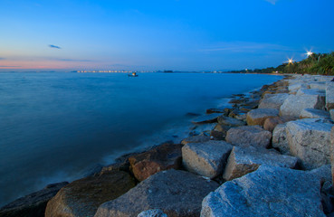 Fototapeta na wymiar The rocky coastline with the blue sky and Blue Sea in Thailand