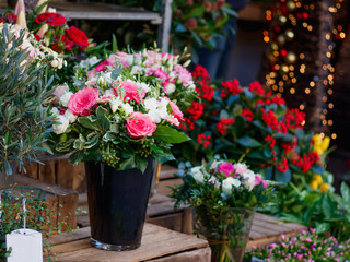 Fototapeta na wymiar View of a bouquet of scarlet roses in a street flower shop in Paris, France.