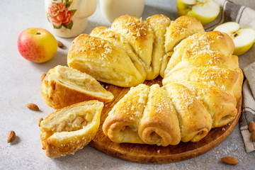 Fresh Homemade baking. Cake Buns with Apples and Almond on a light stone background.
