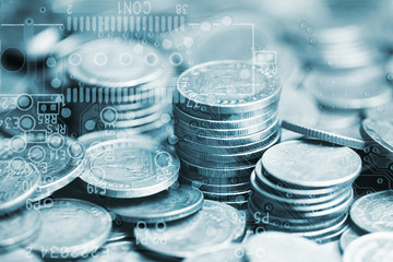 Double exposure of stack of coins and graphics card with graph for business finance concept