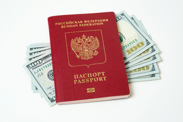 Biometric travel passport of the Russian Federation with dollars isolated on white background. Five bills for a hundred dollars. The concept of tourism. The concept of investment. Closeup.