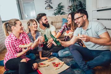 Group of young friends eating pizza.Home party.Fast food concept.