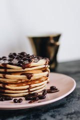 Stack of delicious homemade pancakes with sauce