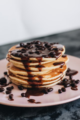 Stack of delicious homemade pancakes with sauce