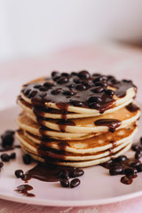 Stack of delicious homemade pancakes with sauce