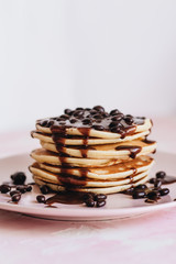 Stack of delicious homemade pancakes with sauce