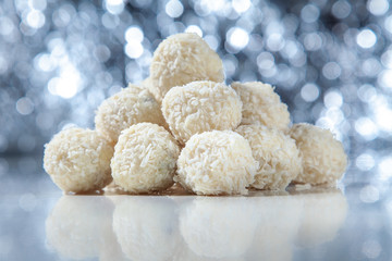 White chocolate sweet candies with coconut flakes.