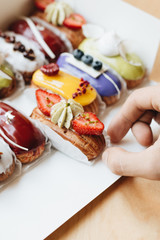 Set of delicious eclairs with glaze, colorful dessert