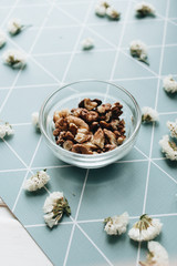 Pile of shelled walnuts in glass bowl, healthy eating concept