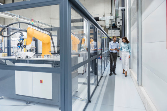 Businessman and woman having a meeting in high tech company