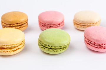 Closeup of tasty macarons on white background