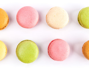 Top view of two rows of French macarons isolated on white - closeup