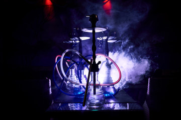 hookahs are on the table in colored smoke