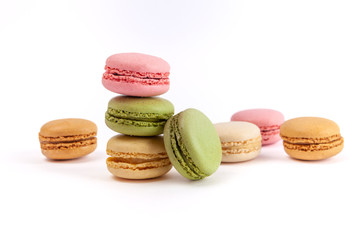 Decorative arrangement of colorful French macarons isolated on white background with copy space