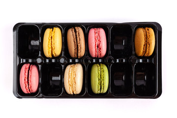French macarons in a package with empty slots - top view