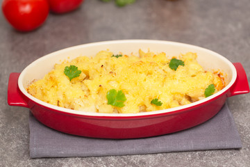 Cauliflower, tomatoes and cheese gratin in the baking dish