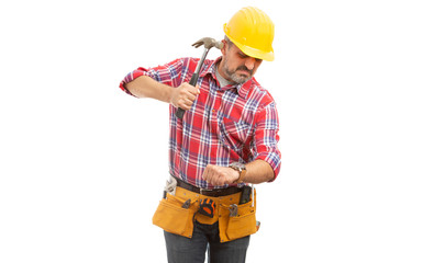 Builder preparing to destroy wristwatch with hammer.