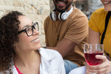 College students having a great time at cafe bar outdoor. Summer, warm, friendship, diversity, reunion concept