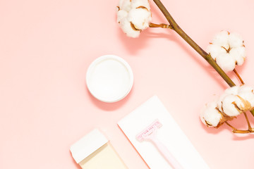 Beauty, depilation and hair removal concept on pink background with a sprig of cotton.