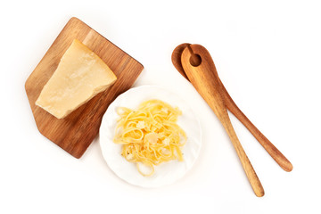 A photo of a plate of Italian pasta with Parmesan cheese, shot from the top on a white background...
