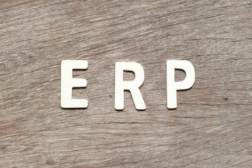 Alphabet letter in word  ERP (Abbreviation of Enterprise Resource Planning) on wood background
