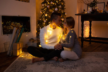 Couple hugging at home at Christmas time