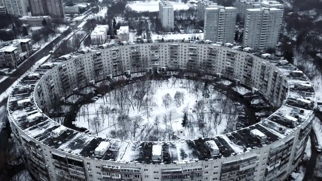 Aerial view of a 9-storey residential building in the form of a ring built in the late 1970s. Moscow, winter.