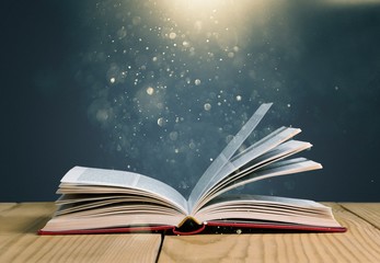 Open book on old wooden table