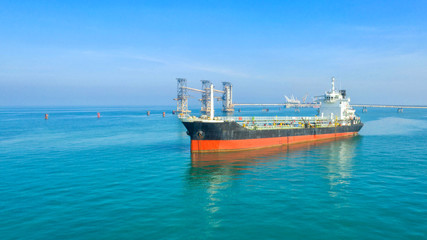Oil tanker, gas tanker in the high sea.Refinery Industry cargo ship,aerial view,Thailand, in import export, LPG,oil refinery, Logistics and transportation with working crane bridge in harbor