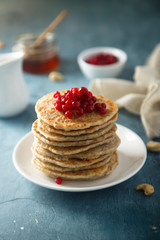 Pancakes with red berries and honey