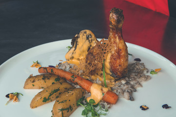 Grilled chicken leg with boiled potatoes and vegetable salad