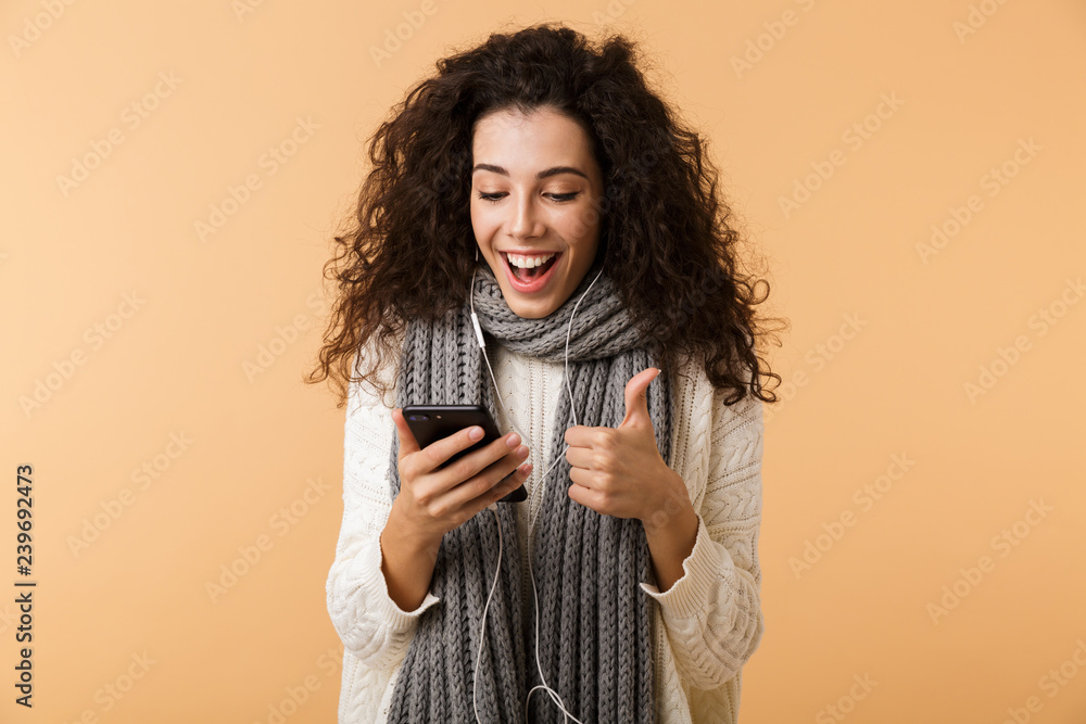 Poster cheerful young woman wearing winter scarf