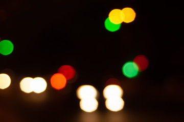Blurred night background of city street road with bokeh effect. Abstract wallpaper for design and editing images.