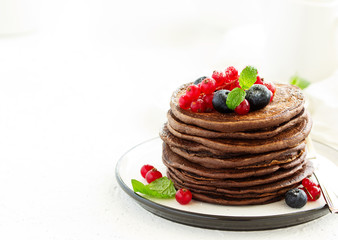 Chocolate pancakes with berries.