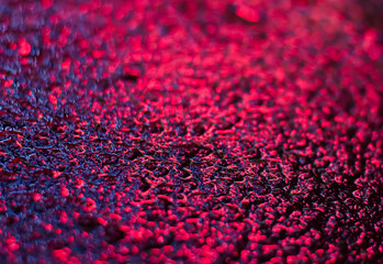 Spectacular texture with bright stains on wet asphalt.