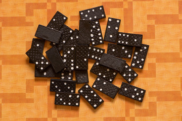 Black dominoes on an orange background