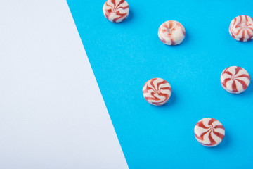 Round candy red and white on a blue background