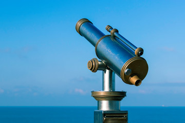Amazing view of metallic telescope in front of the sea and blue sky- Image