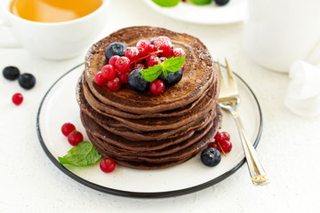 Chocolate pancakes with berries.